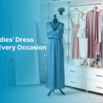 Mannequin wearing a blue dress surrounded by other stylish dresses and accessories in a clothing store. | Ladies Dress