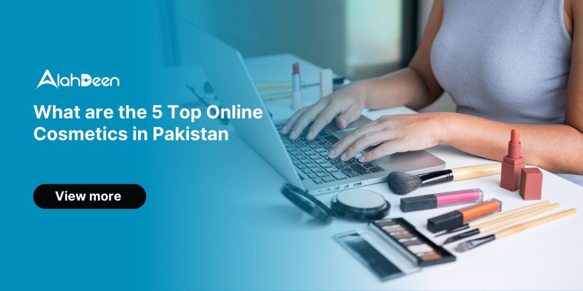 Person typing on a laptop with makeup items like brushes, lipsticks, and eye shadow palettes on the desk - Alahdeen logo with text 'What are the 5 Top Online Cosmetics in Pakistan' and 'View More' button.