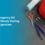 Flat lay of an emergency first aid kit featuring scissors, pills, cotton swabs, gloves, and a red bag labeled "First Aid Kit," promoting safety preparedness during national emergencies.