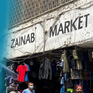 Zainab Market entrance in Karachi with wholesale clothing shops and people shopping