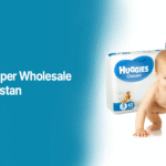 Baby with diaper packs of Huggies and Pampers, highlighting "How to Start Diaper Wholesale Business in Pakistan" by Alahdeen.