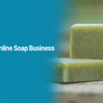 Natural handmade soap bars placed on a wooden surface, representing an online soap business guide by Alahdeen.